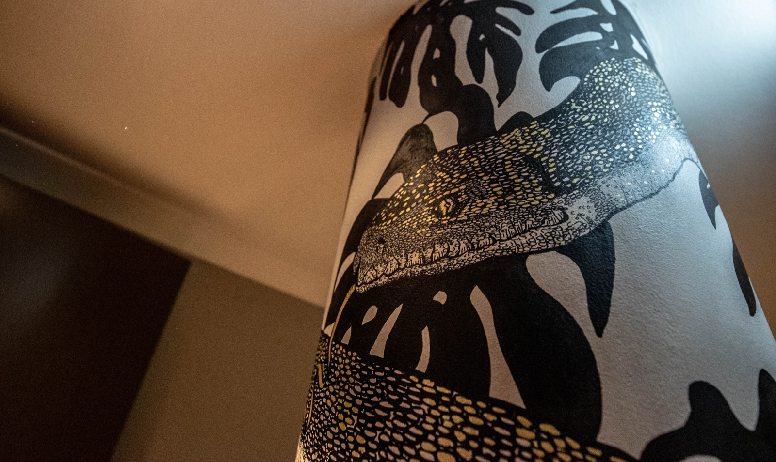 Detail of the crocodile and palm wallpaper inside Holmes Hotel London